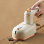 Compact white mini ironing machine with foldable design and steam feature for travel and fabric care.