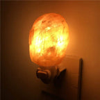 Hand carved Himalayan salt lamp night light with plug emitting warm white glow and purifying air