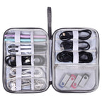 Gray waterproof travel cord organizer bag with multiple compartments and elastic loops for cables and accessories
